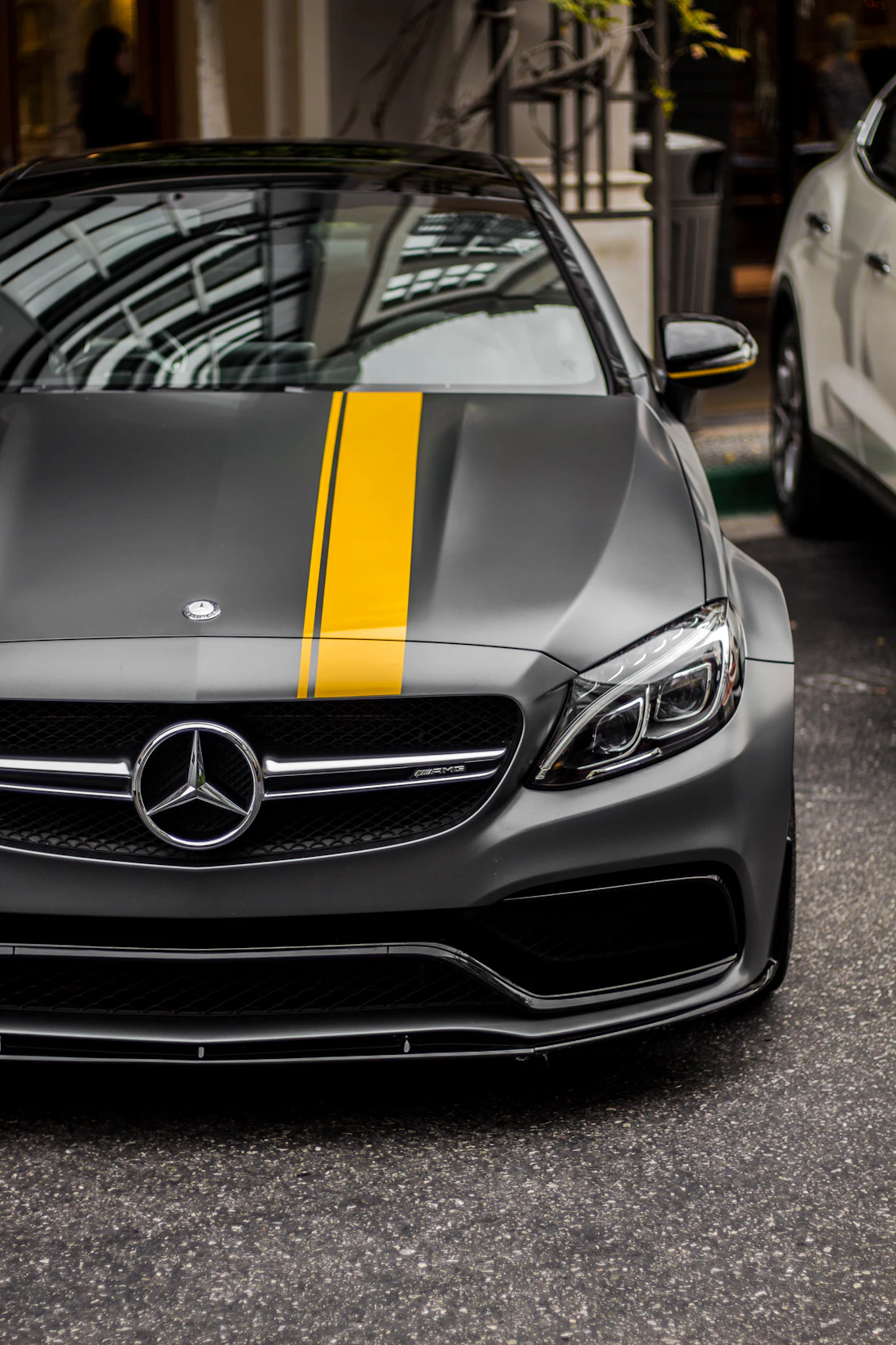 Grey Mercedes AMG C 63 with a yellow stripe