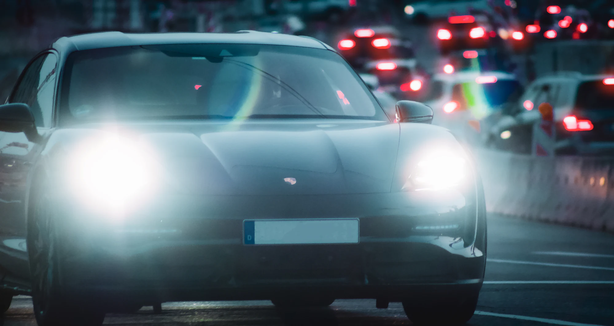 Headlights of a sports car in night traffic